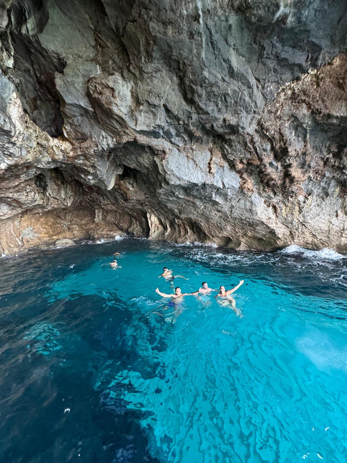 Guests swimming in a sea cave